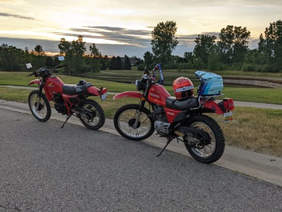 Old enduro motorcycles at sunset after a long ride.